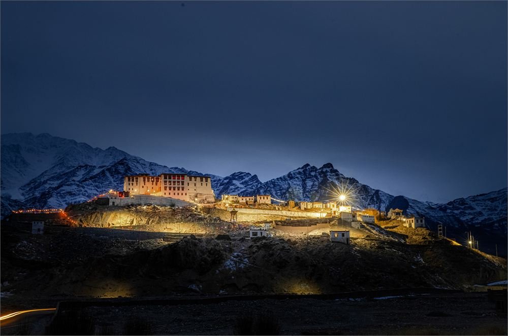 Stok Palace lit beneath the winter peaks