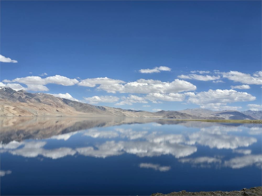 A high-altitude Ladakhi lake mirroring the clouds